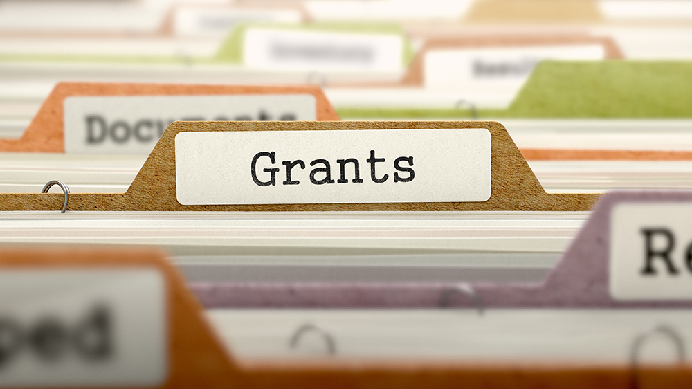 Grants - Folder Register Name in Directory. Colored, Blurred Image. Closeup View.